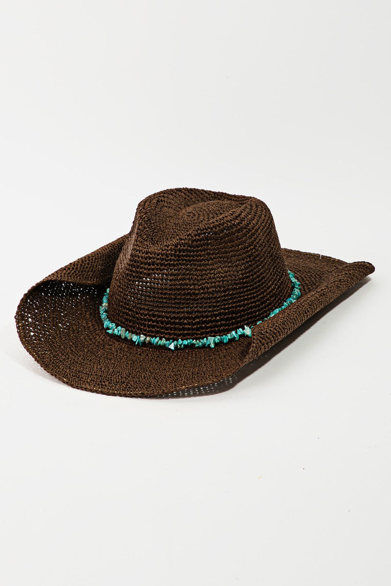 Featuring a curved brim hat with a blue stone belt detail in the color brown 