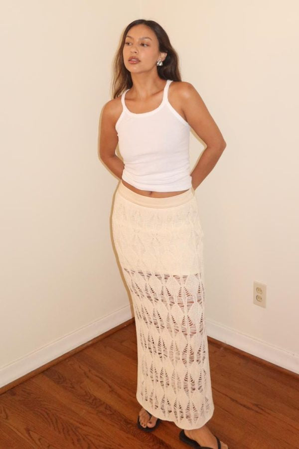 Featuring a partially lined crochet midi skirt in the color beige 
