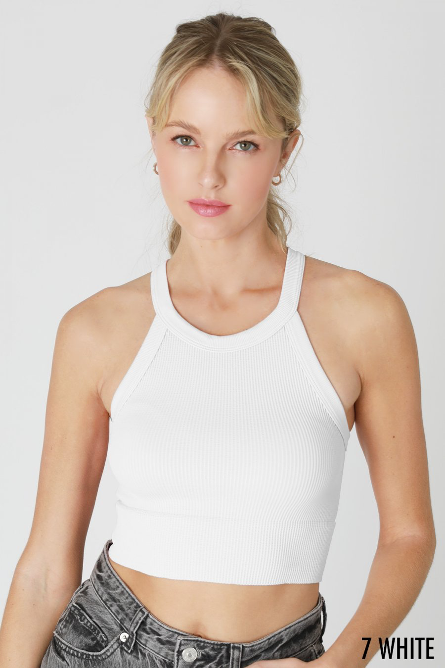 Featuring a seamless, ribbed, high neck cut tank top with a cropped fit in the color White.