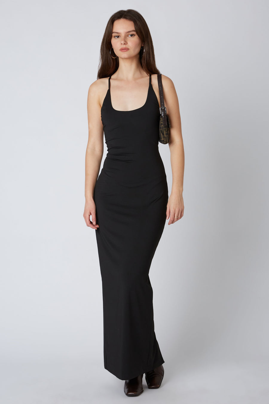 Model is wearing a maxi dress with halter neckline.