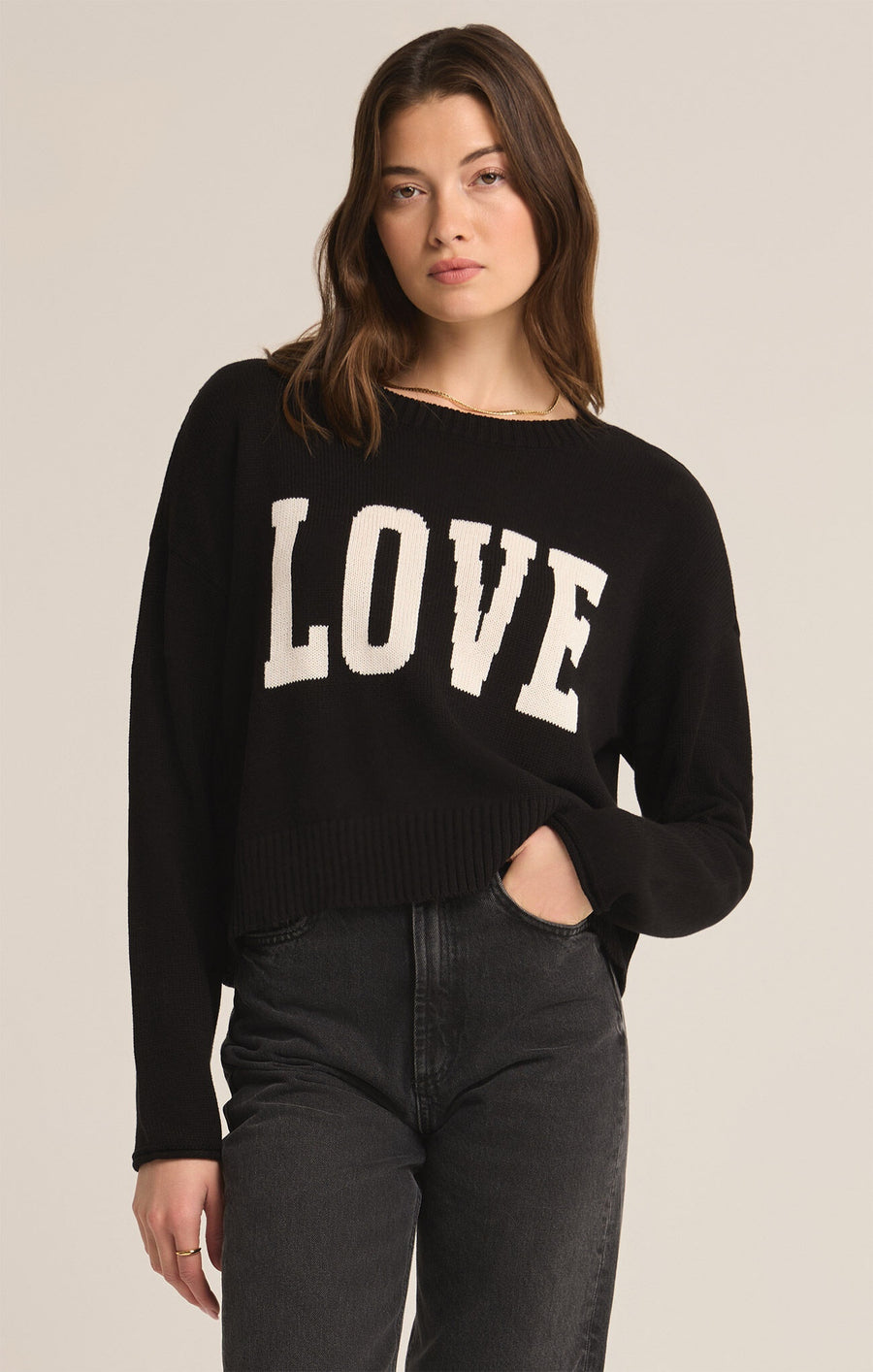 Featuring a long sleeve knit sweater with the word "Love" on the front in the color black 