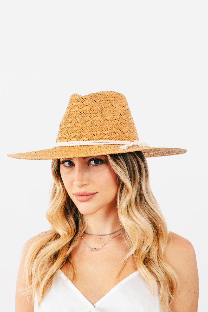 Featuring a woven hat in the color tan