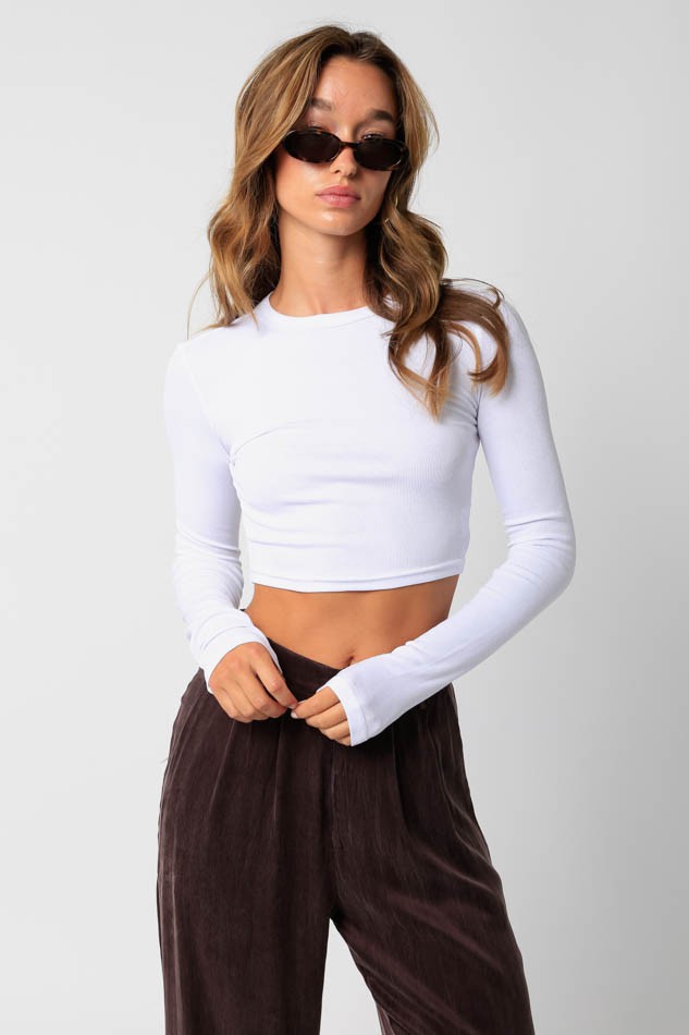 Featuring a fitted long sleeve crop top in the color white 