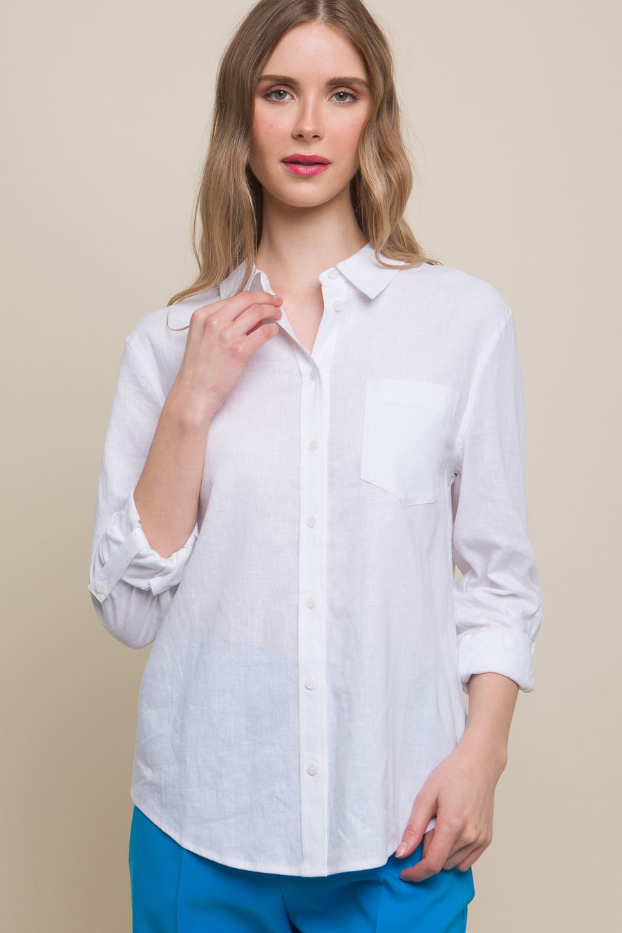 Featuring a collard linen button up with front chest pocket in the color white 