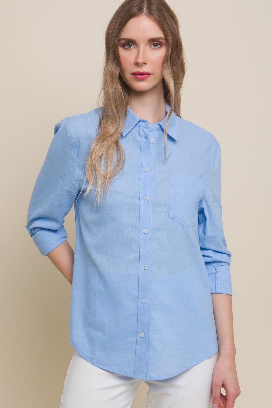 Featuring a collard linen button up with front chest pocket in the color light blue 
