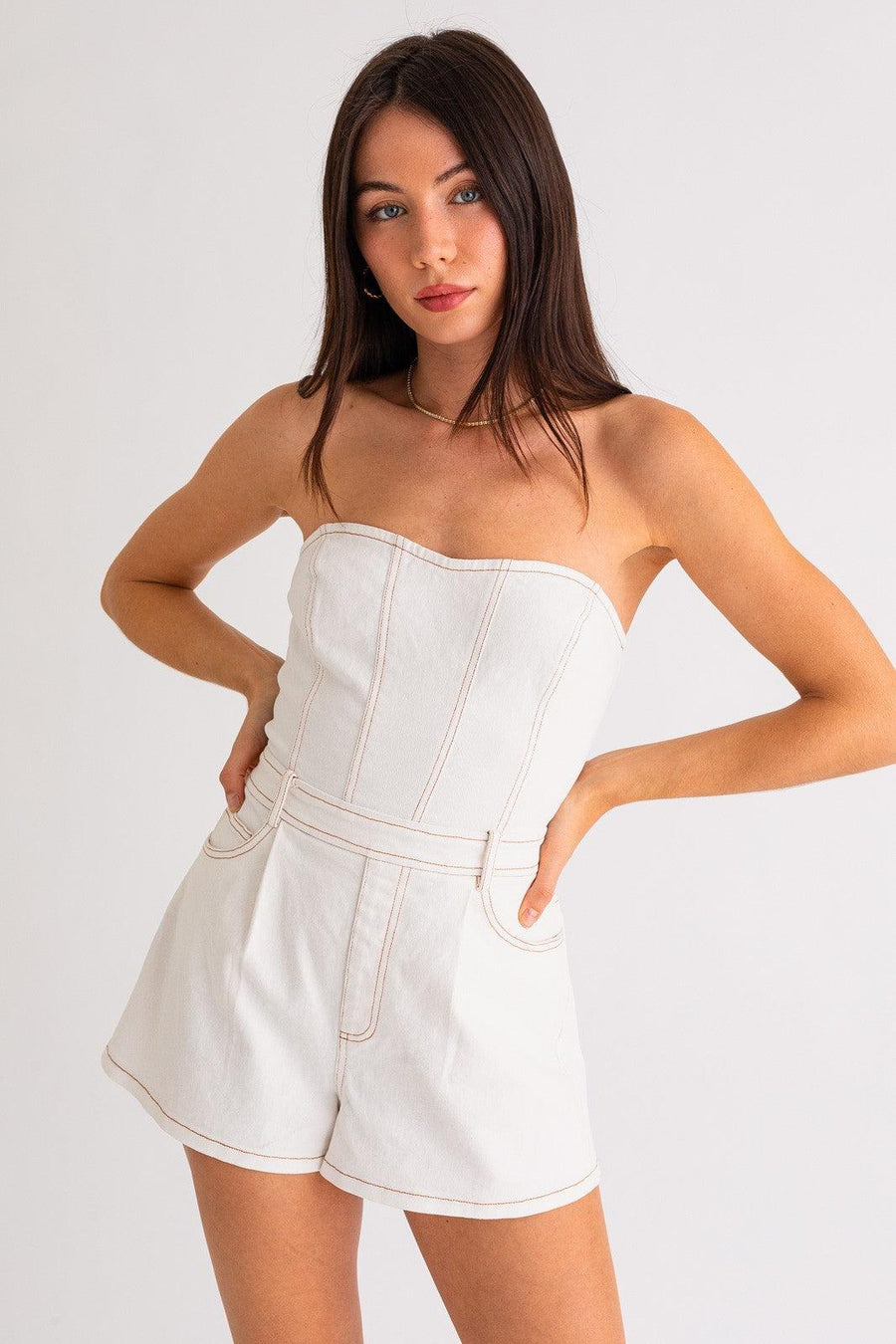 white denim mini romper with contrast stitching.