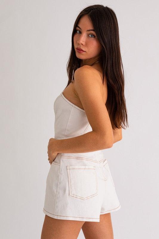 white denim mini romper with contrast stitching.