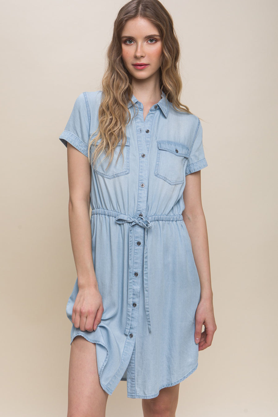 Featuring a short sleeve front tie collard mini dress with two chest pockets in the color light blue 