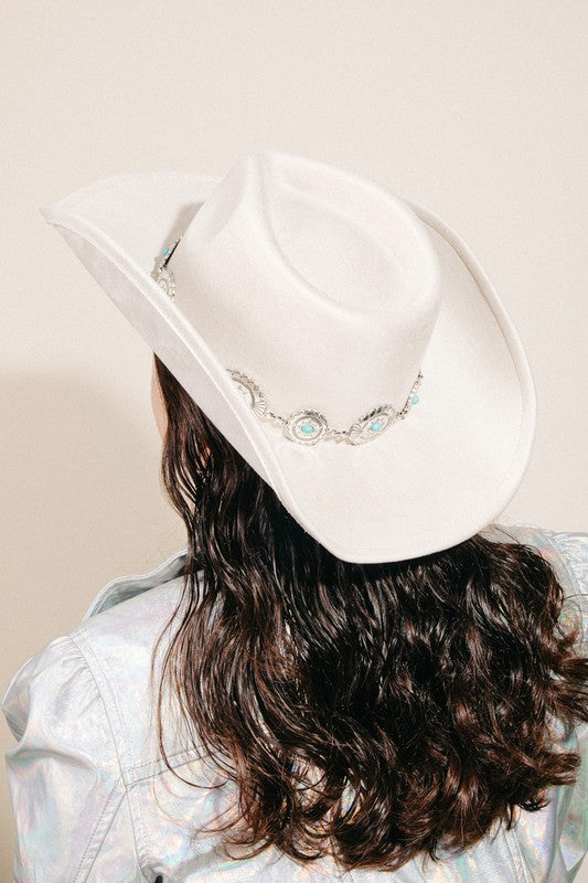 Featuring a cowboy style hat with a silver belt detail in the color ivory 