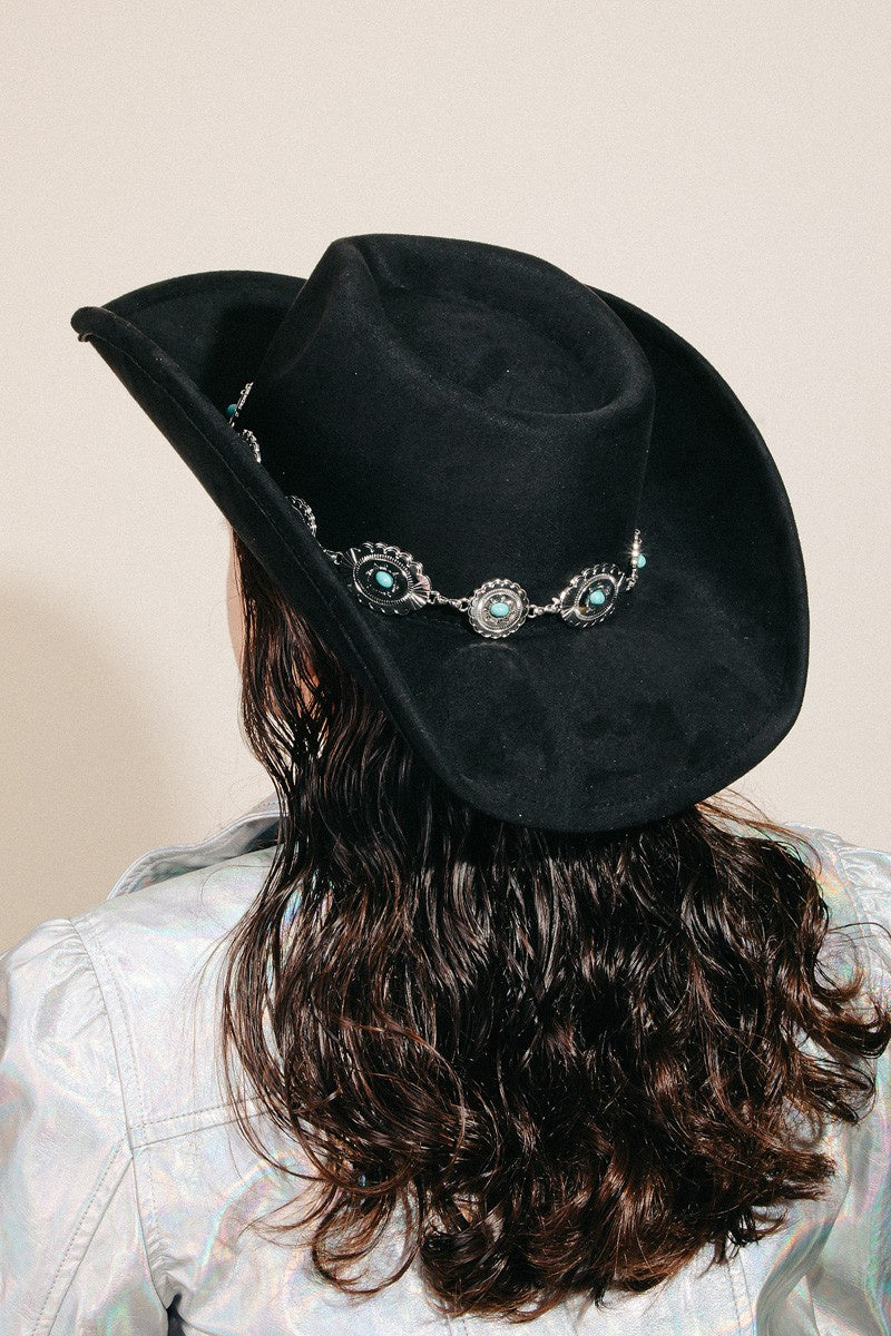 Featuring a cowboy style hat with a silver belt detail in the color black 