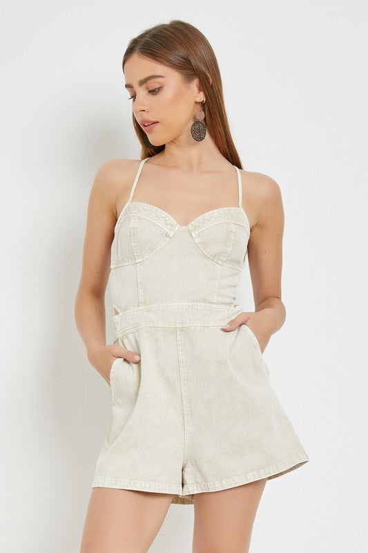 Featuring a thin strap open lace up back romper with a heart shaped neck line and pockets on each side in the color ecru