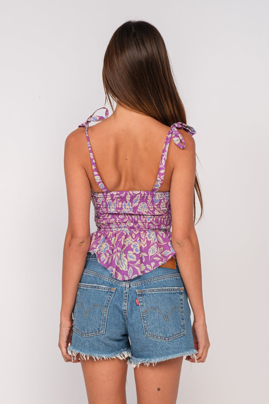 Floral top with tied straps and ruffle bottom.