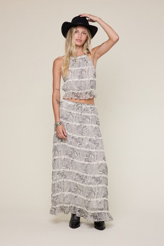 Pairs with the matching 'Zayla Skirt'

Featuring a black-white paisley print top with halter tie neck