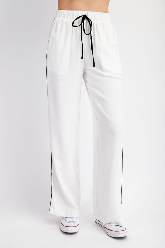 Featuring a textured woven draw string pant in the color white 