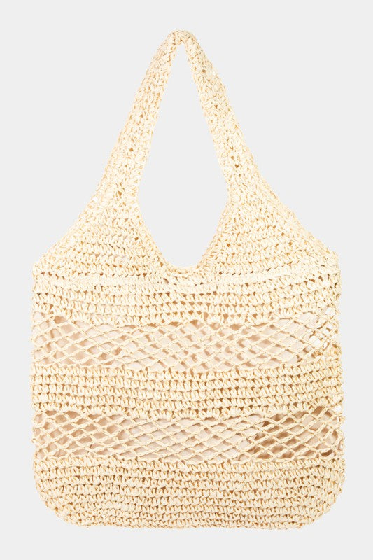 Featuring a woven tote bag with inner lining and a zipper closure in the color ivory