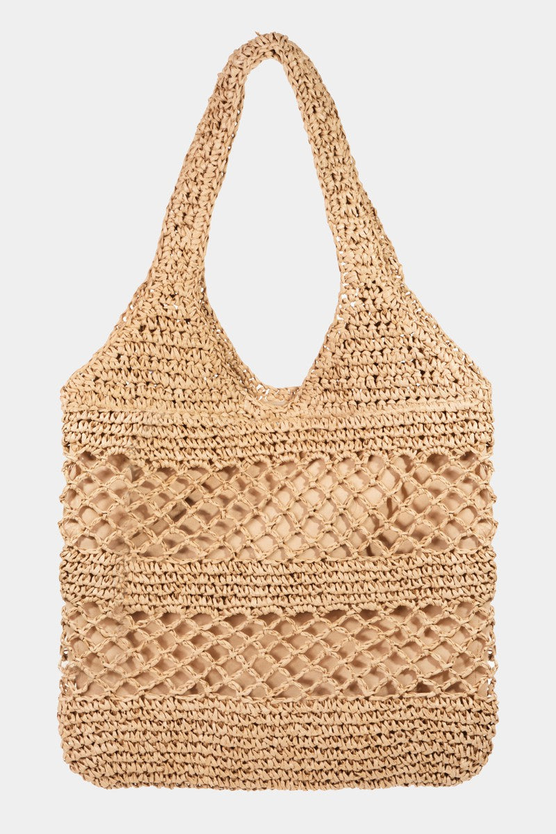 Featuring a woven tote bag with inner lining and a zipper closure in the color khaki