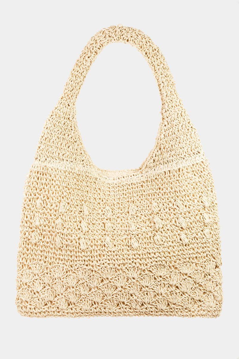 Featuring a woven tote bag with inner lining in the color ivory