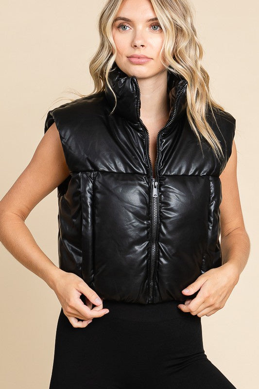 Featuring a PU shiny sleeveless vest in the color black