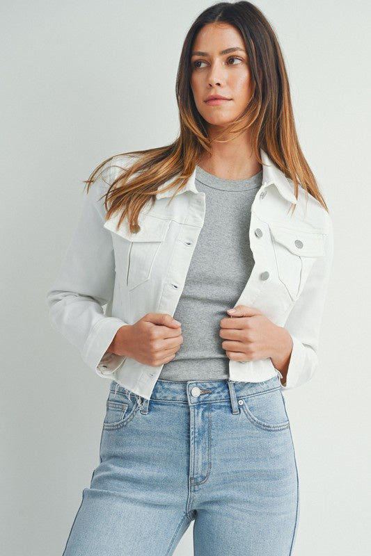 Featuring a cropped denim jacket with a frayed hem in the color white 