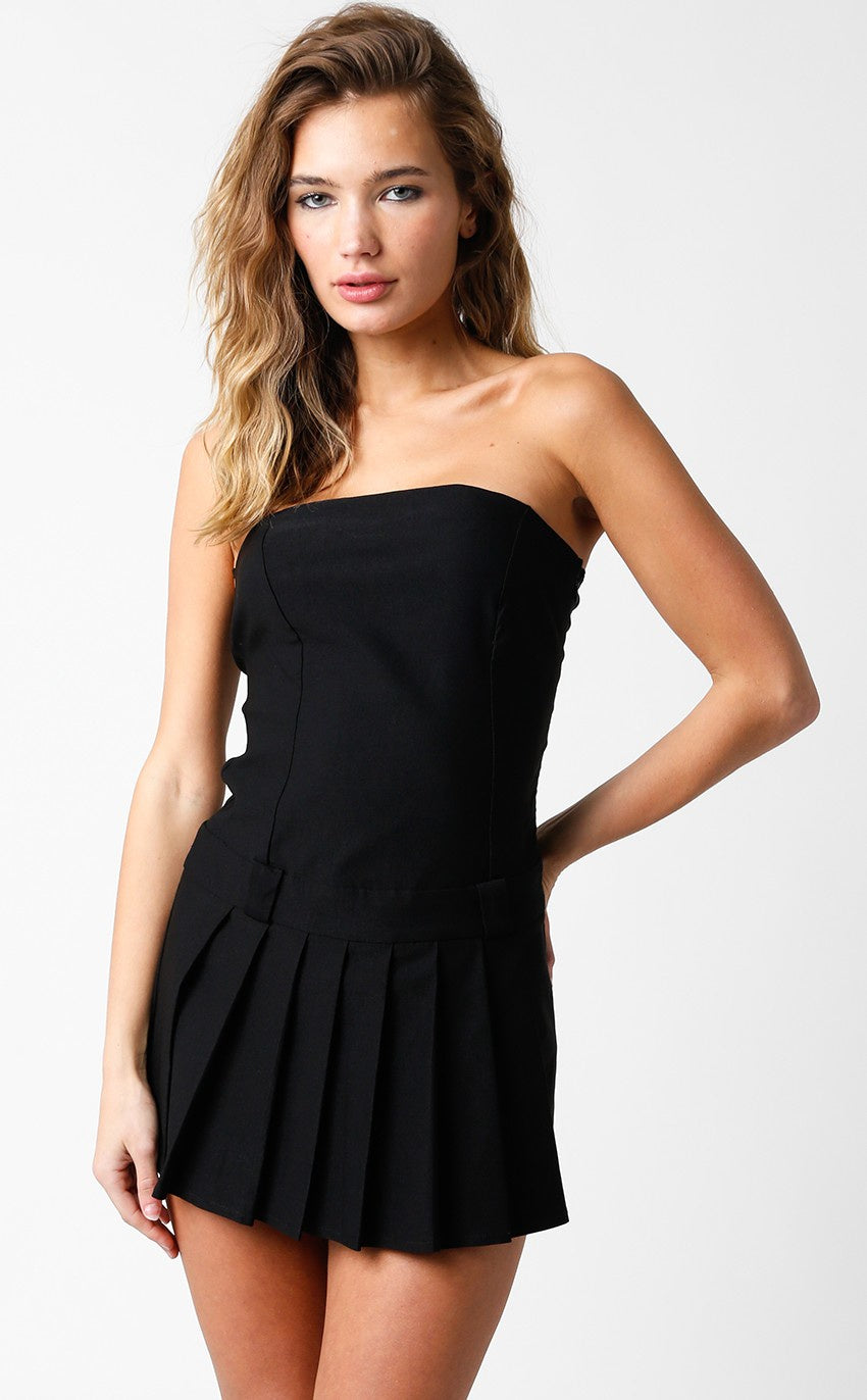 Featuring a strapless pleated mini dress with belt buckle detail and a side zip int the color black 