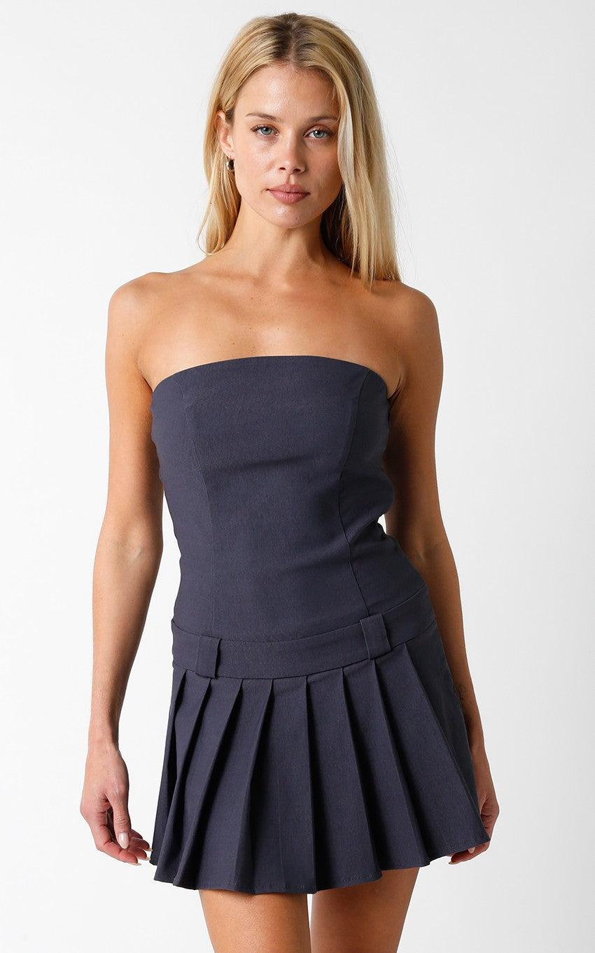 Featuring a strapless pleated mini dress with belt buckle detail and a side zip in the color Grey