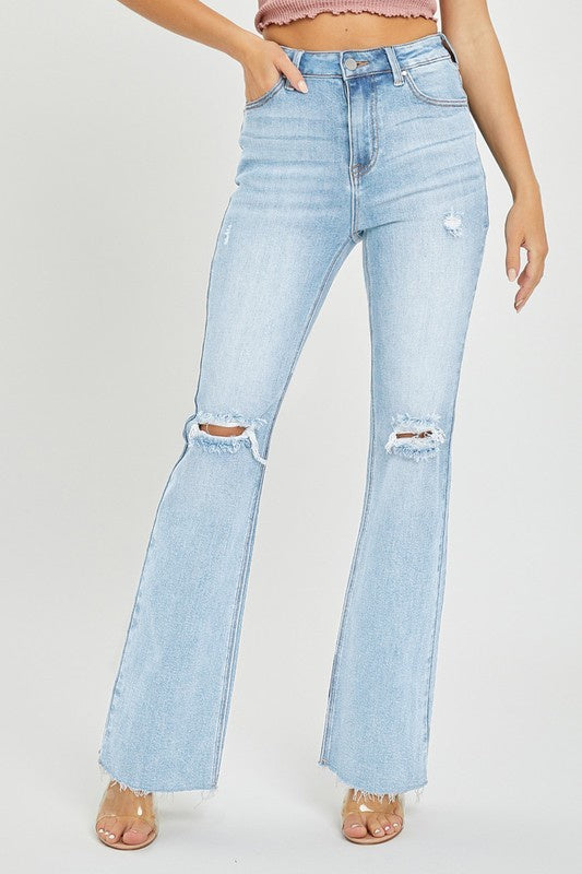 Featuring a high waisted distressed flare jean in a light wash