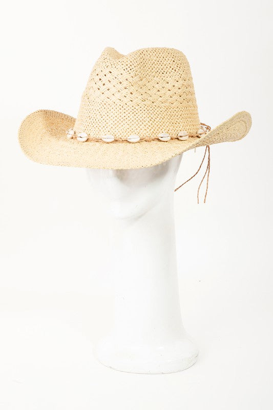 Featuring a woven straw hat with a shell lined strap in the color ivory 
