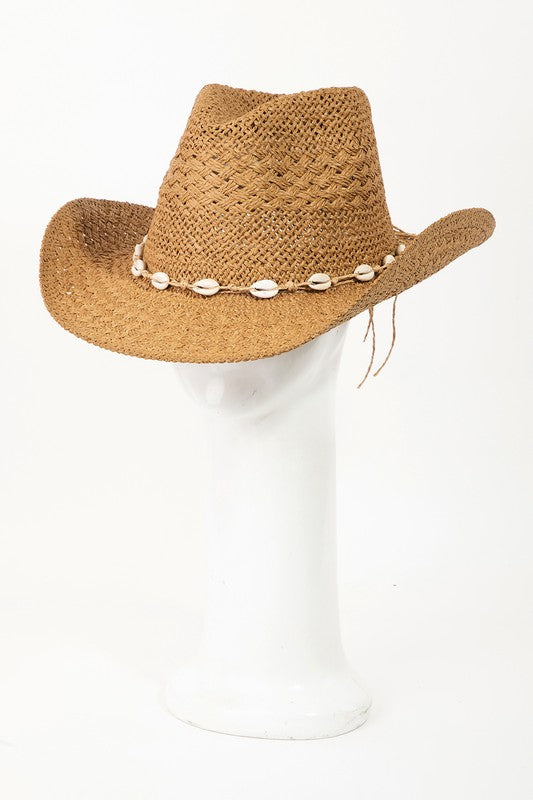 Featuring a woven straw hat with a shell lined strap in the color tan