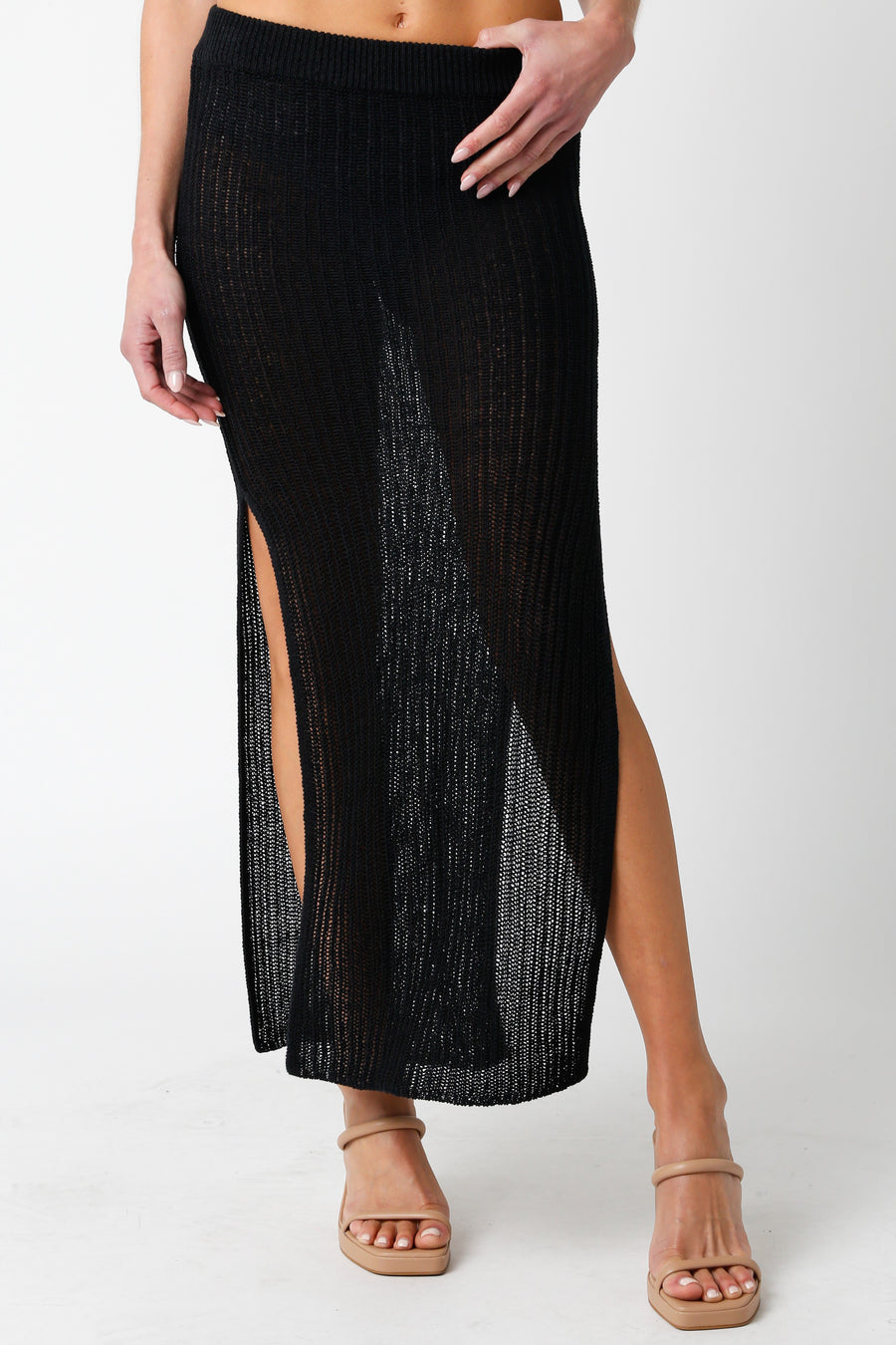 Featuring a wide knit midi skirt with slits on each side in the color black 