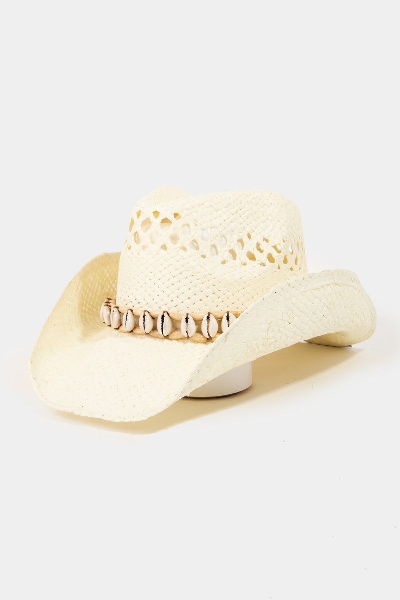 Featuring a woven sea shell lined cowboy style hat in the color ivory 