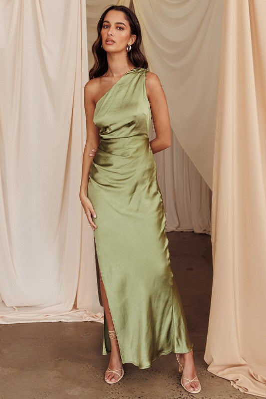 Featuring a one shoulder satin maxi dress with a side slit in the color olive 