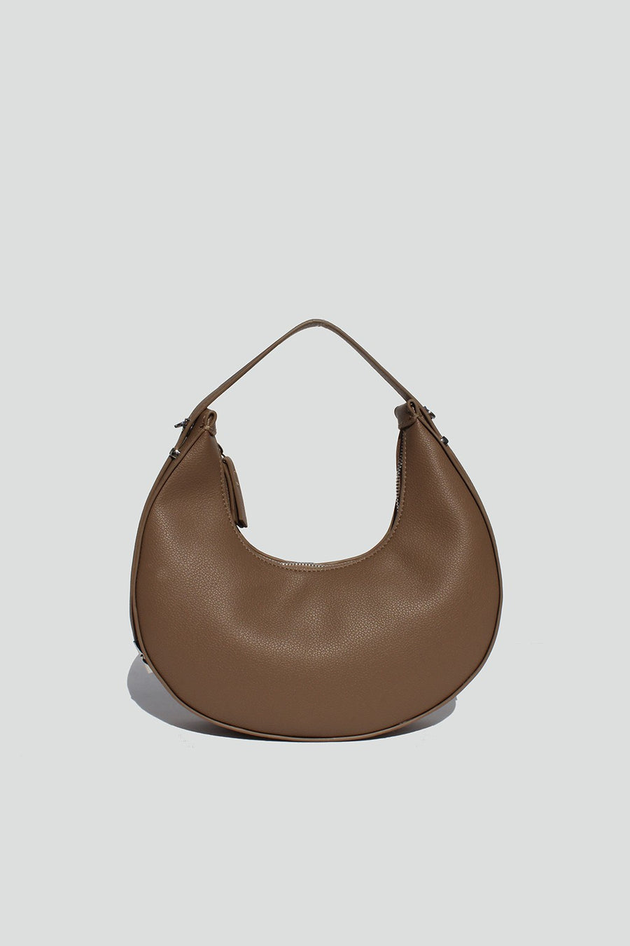 Featuring a Shoulder/Crossbody bag, comes with an adjustable strap and two interior pockets in the color taupe 