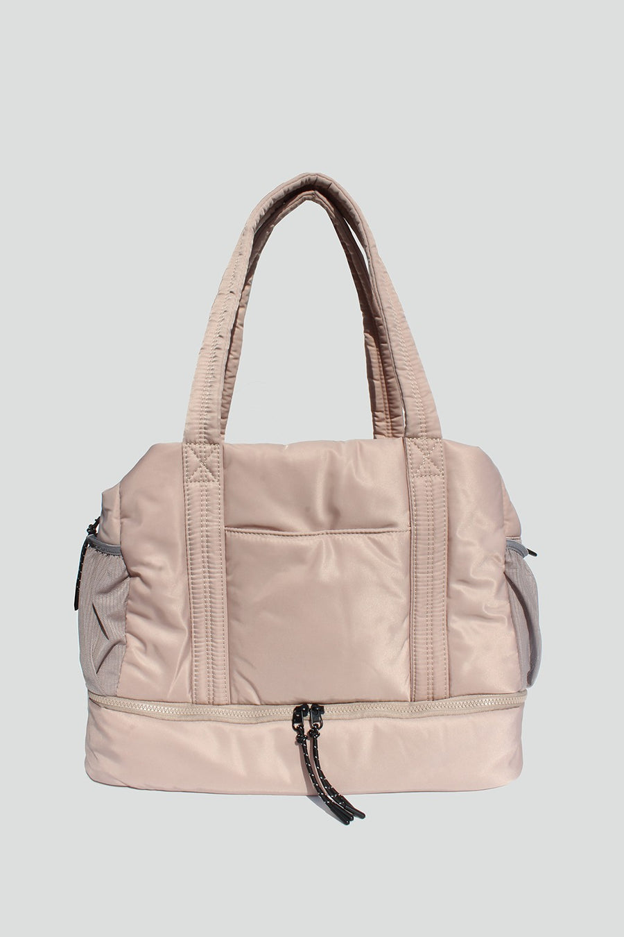 Featuring an over the shoulder/Crossbody duffle style bag with triple interior compartments and adjustable detachable straps in the color ivory 