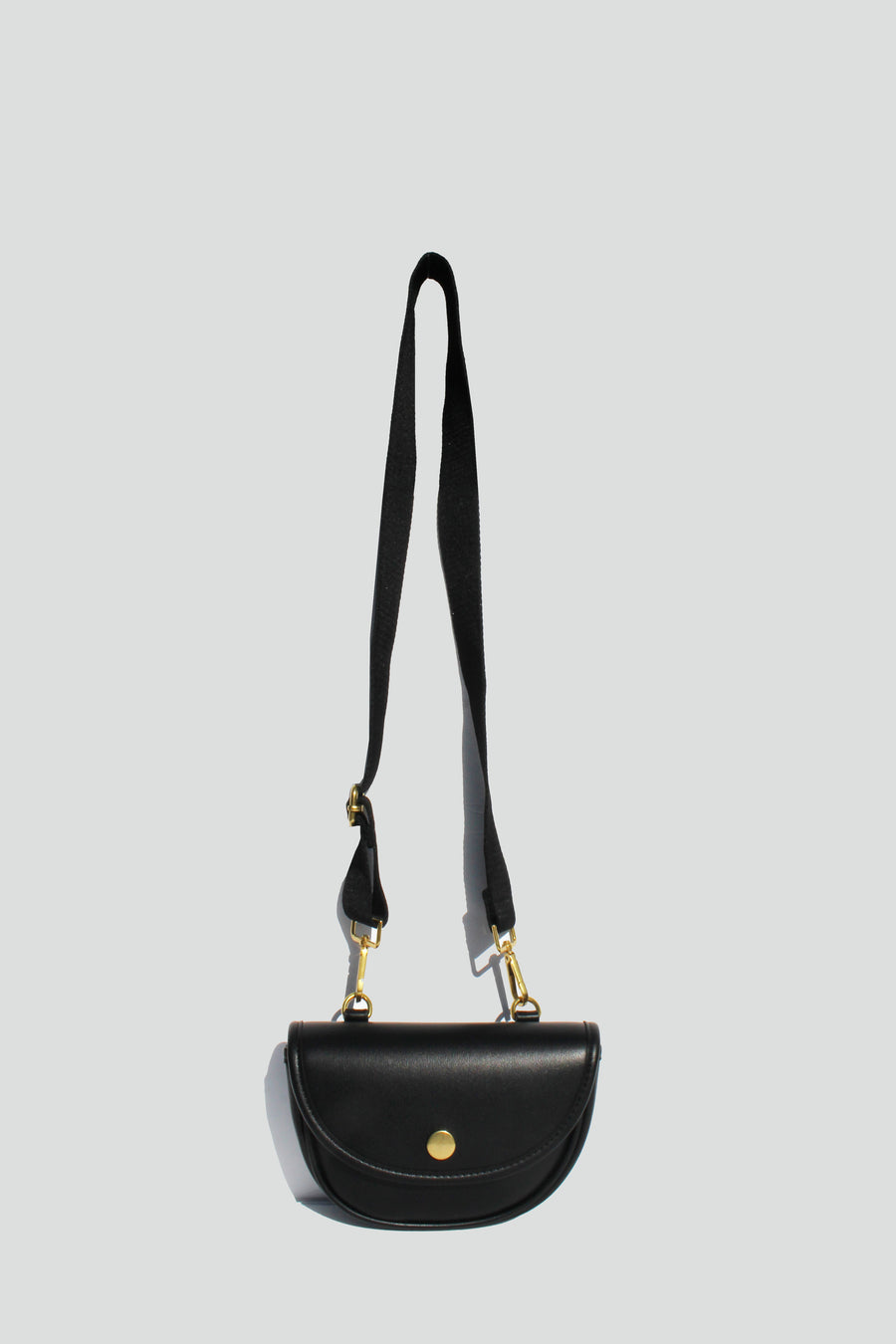 Featuring a small multi compartment crossbody bag with an adjustable strap in the color black