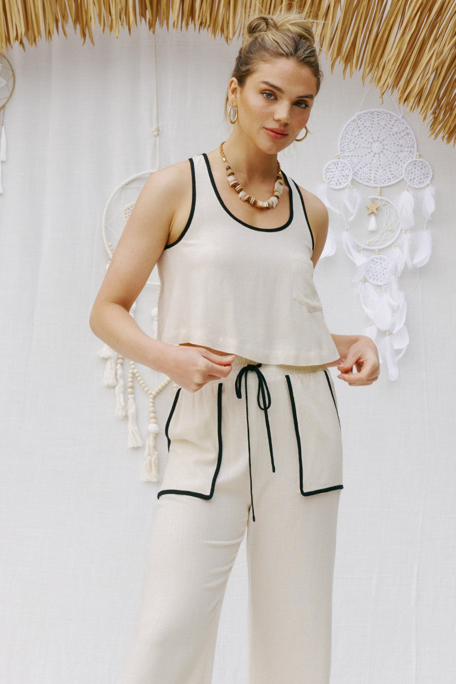 Pairs with the matching "Imogen Linen Pant"  Featuring a open tie back cropped tank in the color natural 