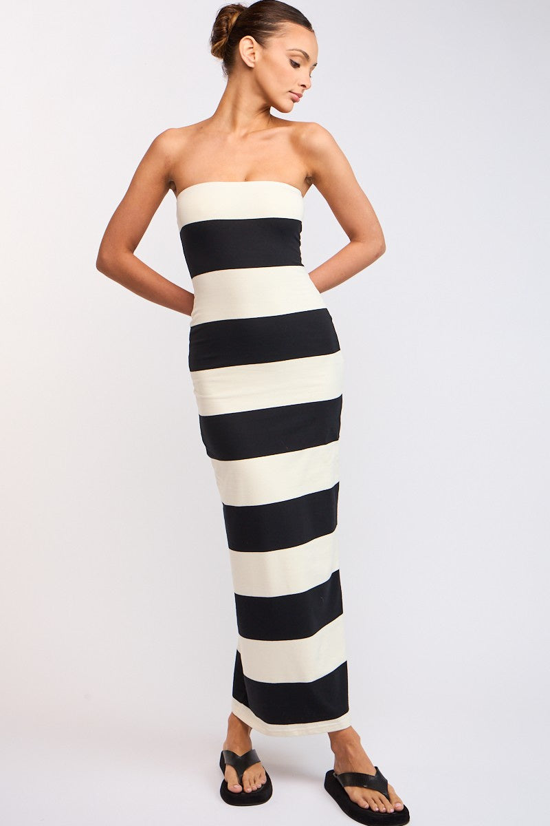 Featuring a fitted strapless striped maxi dress in the colors black and ivory 