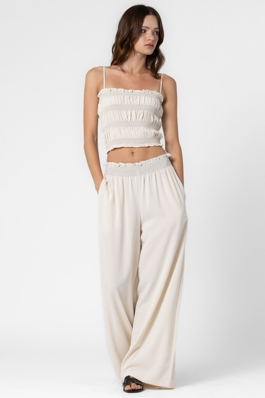 Wide leg, loose fit pants with elastic waistband and ruffle details.