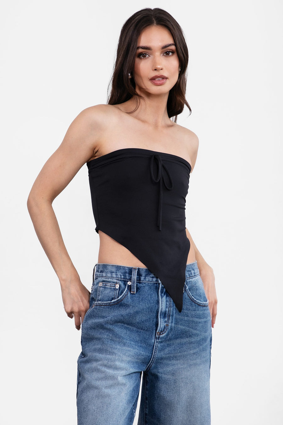 Featuring an Asymmetrical Tube top with a front tie detail in the color black 
