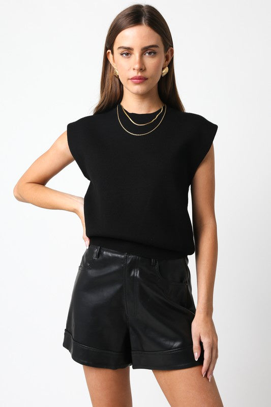 Featuring a loose short sleeve sweater in the color black