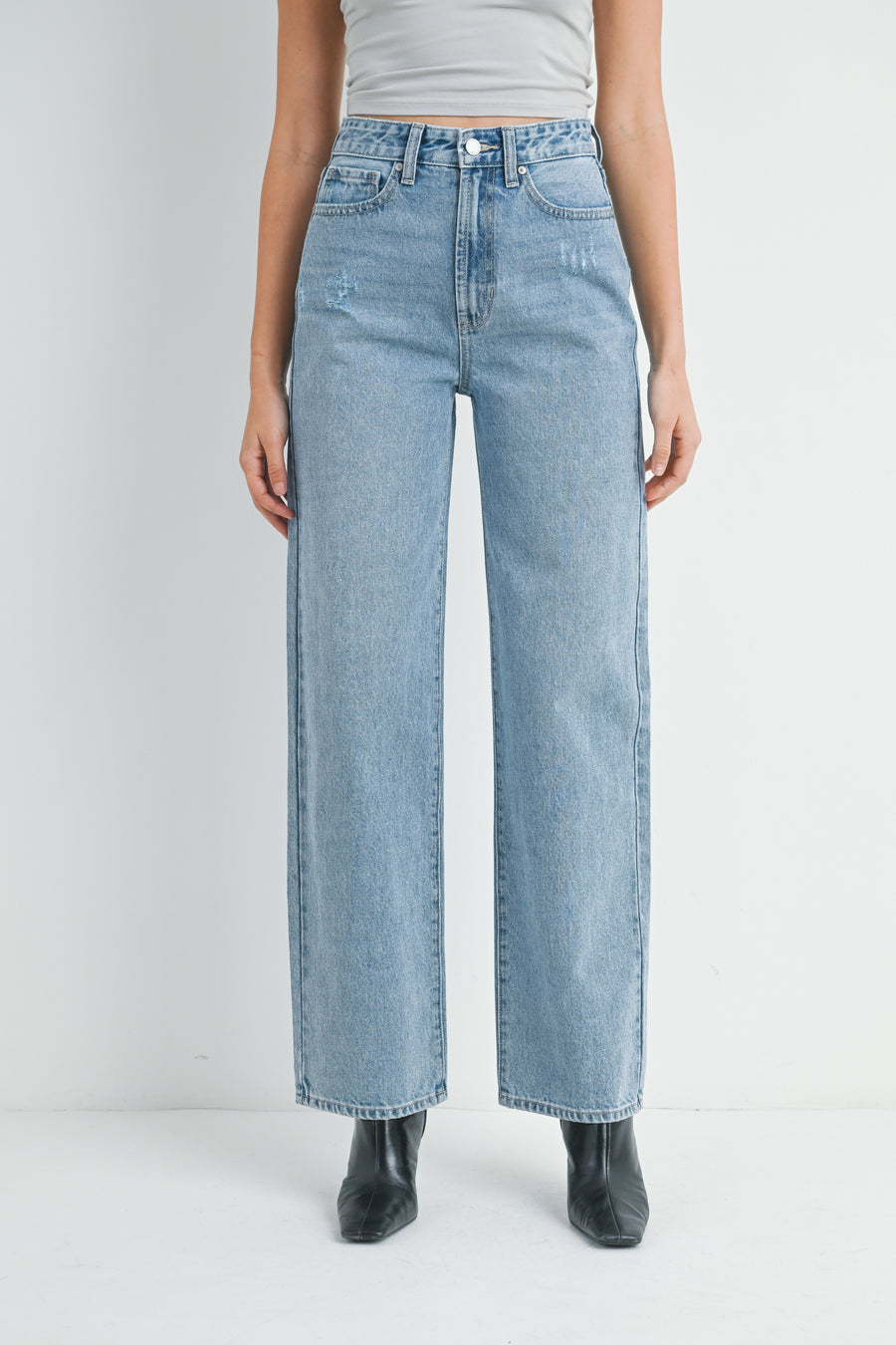 Featuring a high rise slim cut straight leg jean in the shade light denim