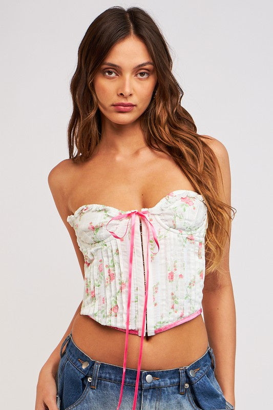 Featuring a floral strapless corset top with hook eye closures in the front and a front center bow detail in the color pink floral