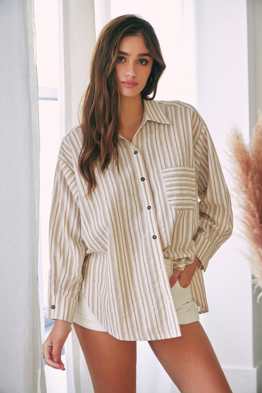 Featuring a long sleeve button up with beige and tan stripes