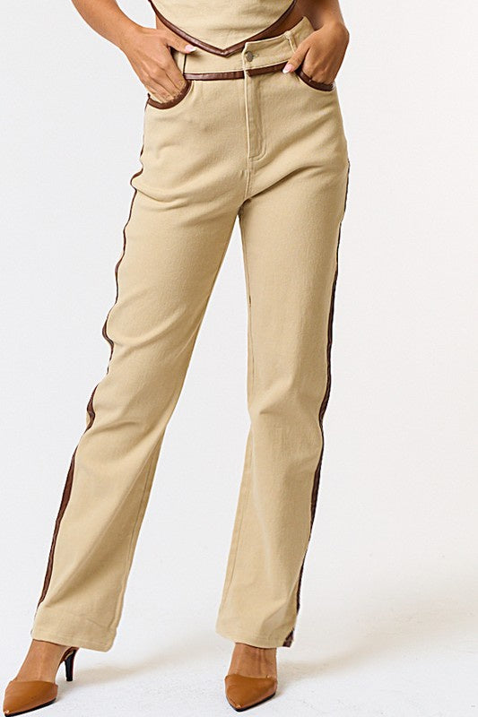 Featuring a contrast leather straight leg pants in the color taupe-brown