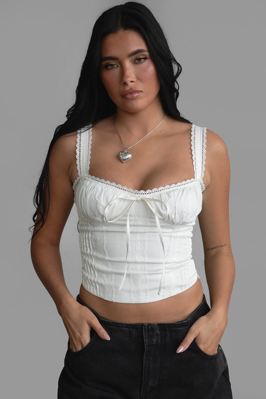 Featuring a corset style top with a sweetheart neckline and lace detailing.