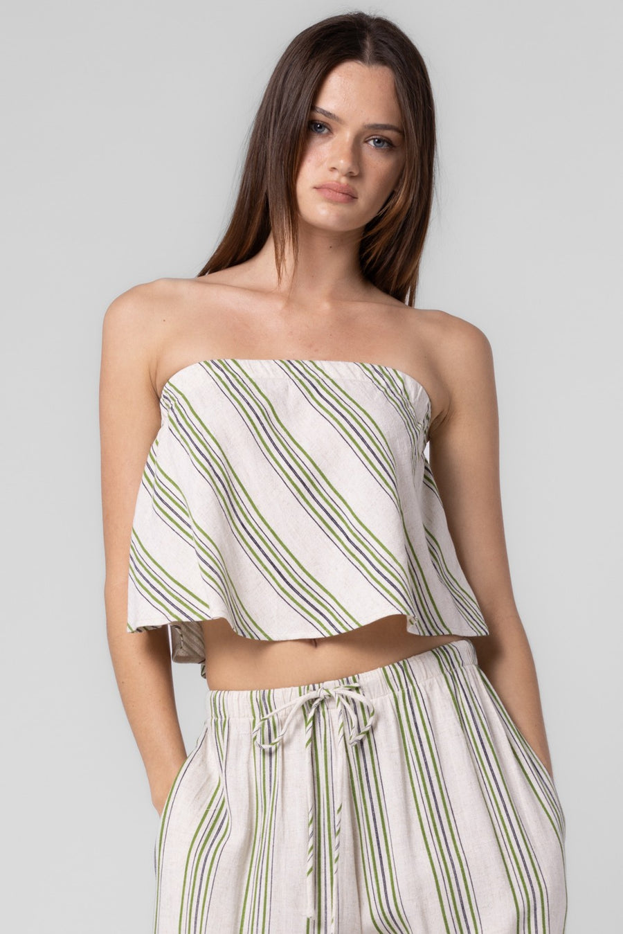 Pairs with the matching Wailyn Striped Pant

Featuring a flowy diagonally striped tube top in the colors green and ivory 