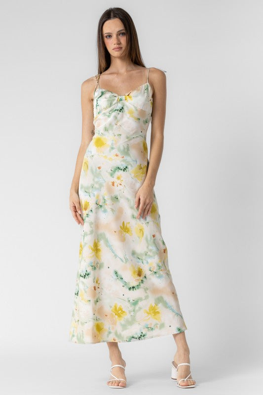 Featuring a multi colored floral midi dress with adjustable tie staps and a knotted front detail in the color green 