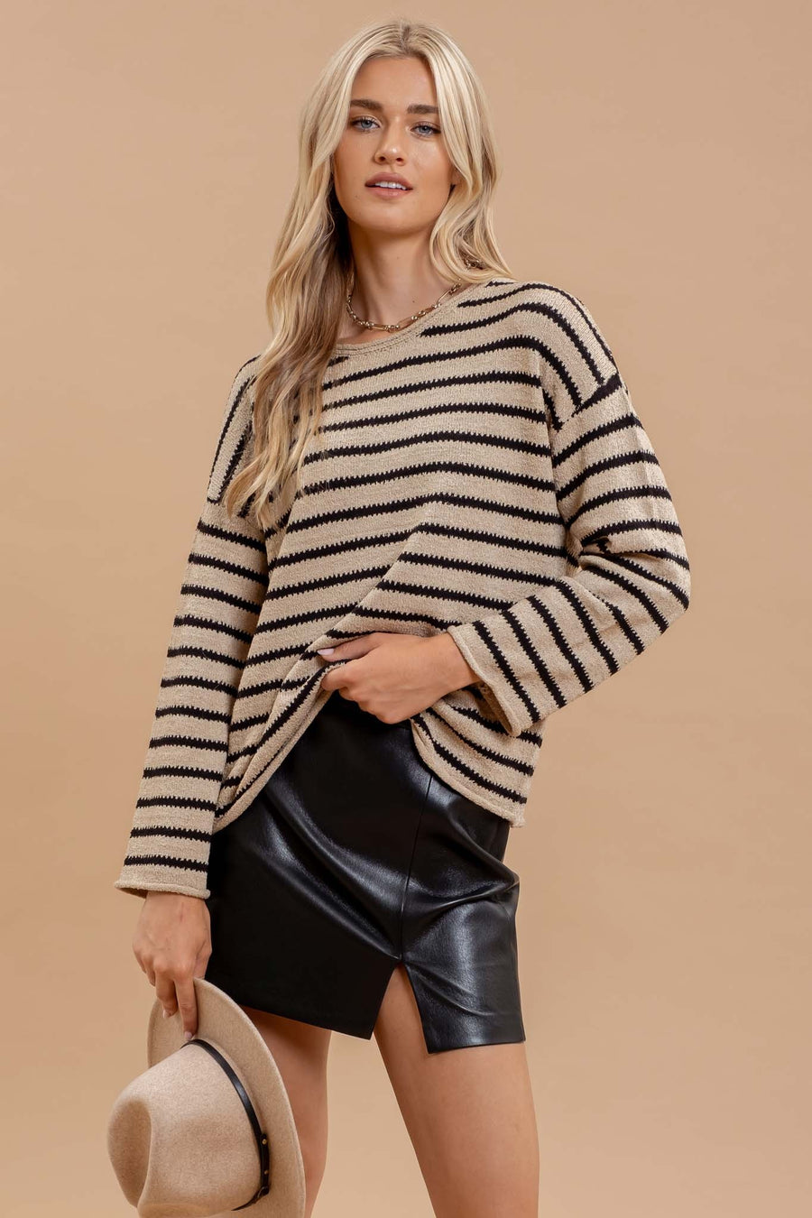 Featuring a striped drop shoulder sweater with wide long sleeves in the color taupe and black 