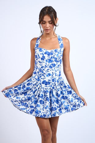 Featuring a wide halter neck, fit and flare mini dress in a blue-navy floral print.