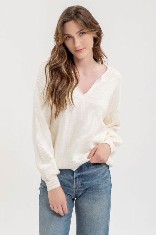 Featuring a V-neck long sleeve top

In the color cream 