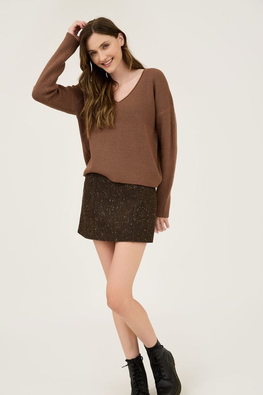 Featuring a V-neck ribbed sweater in the color mocha 